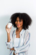 © kanpisut - Joyful young woman enjoying a cup of coffee at home.  woman holding coffee paper cup