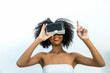 © kanpisut - Woman in VR headset. Happy woman using VR glasses for online game