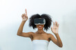 © kanpisut - Woman in VR headset. Happy woman using VR glasses for online game