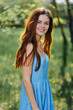 © SHOTPRIME STUDIO - Young woman laughing in nature and smiling with her teeth in spring in blue. dress looking at the camera, happiness outside