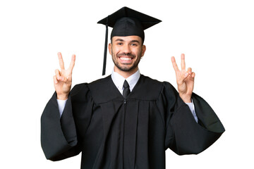 Wall Mural - Young university graduate man over isolated chroma key background showing victory sign with both hands