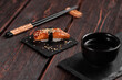 Japanese sushi unagi nigiri sushi smoked eel on wooden background close-up