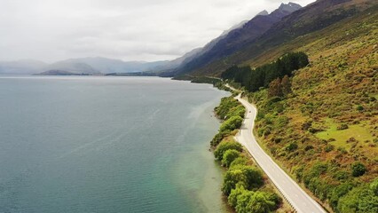 Sticker - Lake Wakatipu in New Zealand – aerial fly over highway 6 by mount edge 4k.
