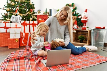 Poster - Mother and daughter watching movie sitting by christmas tree at home