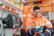 © Rawlstock - smiling paramedic using a cell phone inside an ambulance