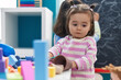 © Krakenimages.com - Adorable chinese toddler playing with toys standing at kindergarten