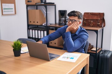 Wall Mural - Young hispanic man business worker using laptop with serious expression at office