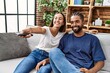© Krakenimages.com - Man and woman couple smiling confident watching tv at home