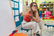 © Krakenimages.com - Young blonde woman teacher sitting on chair with serious expression at kindergarten