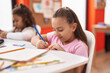© Krakenimages.com - Two kids preschool students sitting on table drawing on paper at classroom