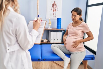 Poster - Young latin woman pregnant patient having physiotherapy session at clinic