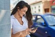 © Krakenimages.com - Young hispanic woman smiling confident using touchpad at street