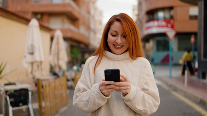 Sticker - Young redhead woman smiling confident using smartphone at street