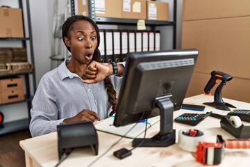 Poster - African woman working at small business ecommerce looking at the watch time worried, afraid of getting late