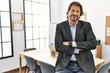 © Krakenimages.com - Middle age caucasian man smiling confident with arms crossed gesture at office
