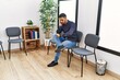 © Krakenimages.com - Young hispanic man desperate sitting on chair at waiting room