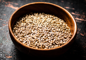 Sticker - Grain in a wooden bowl on the table. 