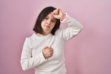 Sticker - Woman with down syndrome standing over pink background touching forehead for illness and fever, flu and cold, virus sick