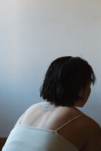 Portrait Of Asian Woman With Tattoo On Back