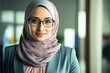 © Adriana - Portrait of confident Beautiful smiling muslim working businesswoman wearing a hijab, suit and eyeglasses. generative AI