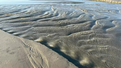 Canvas Print - Saltwater  seawater moving quickly over the sand creating beautiful natural ripples