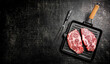 © Artem Shadrin - Raw pork steak in a frying pan.