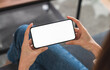 © sitthiphong - Hand holding smartphone mockup of blank screen. Take your screen to put on advertising.