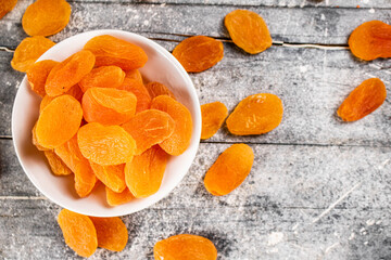 Wall Mural - Fragrant dried apricots in a bowl on the table. 