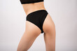 © Павел Костенко - Close-up of female buttocks in lingerie on a white background.