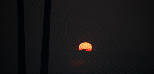 Fototapete - Sun shines through the bridge.