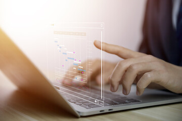 Fototapete - Male manager managing business planning project schedule in the office. Gantt chart showing on virtual screen.	
