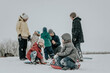 © Westend61 - Happy family having fun together with inflatable sled in snow