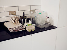 Separated Recycling Waste Standing On Kitchen Cupboard