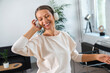© Westend61 - Happy businesswoman wearing headphones listening music and dancing in office