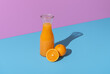 Orange juice carafe and orange fruits isolated on a vibrant background