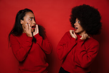 Wall Mural - Two young african american women expressing excitement with mouths open