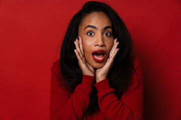 Wall Mural - Young african american woman expressing excitement with mouth open