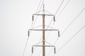 Wall Mural - High voltage power line pole in winter. Background on the theme of energy and transmission of electricity over long distances in difficult conditions, in a cold, snowy climate.