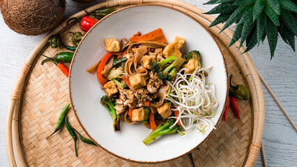 Canvas Print - Udon noodles stir fry with chicken, carrots, onions, broccoli, sweet peppers and green sprouts.