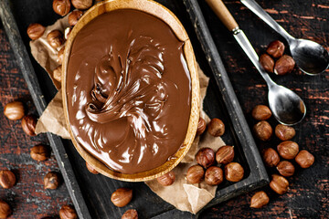 Sticker - Hazelnut butter in a plate on a cutting board with paper.