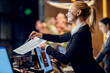 © Dusan Petkovic - A happy receptionist is giving papers to a guest to sign up.
