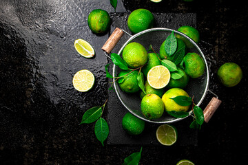 Wall Mural - Fragrant lime with leaves in a colander. 