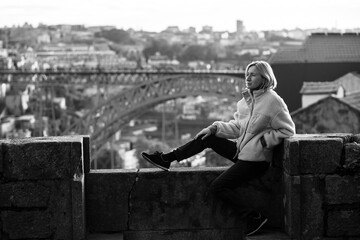 Sticker - Woman on a stone fortress in the downtown, Porto, Portugal. Black and white photo.