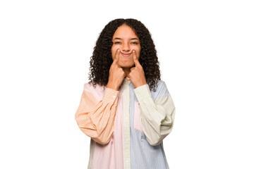 Young african american curly woman isolated doubting between two options.