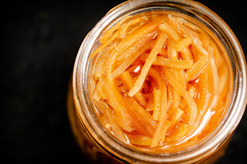 Canvas Print - A glass jar with canned carrots. 