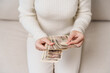 © Jo Panuwat D - Woman hand holding Japanese Yen banknote stack. Thousand Yen money. Japan cash, Tax, Recession Economy, Inflation, Investment, finance and shopping payment concepts