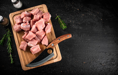 Sticker - Chopped raw pork on a cutting board with knife, spices and rosemary. 