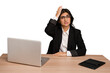 Young indian woman in a table with a laptop and tablet isolated being shocked, she has remembered important meeting.