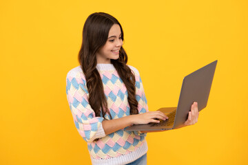 Poster - Teenager school girl hold notebook laptop. School children on isolated studio background.