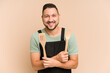 © Asier - Adult latin cook man holding wooden utensils isolated